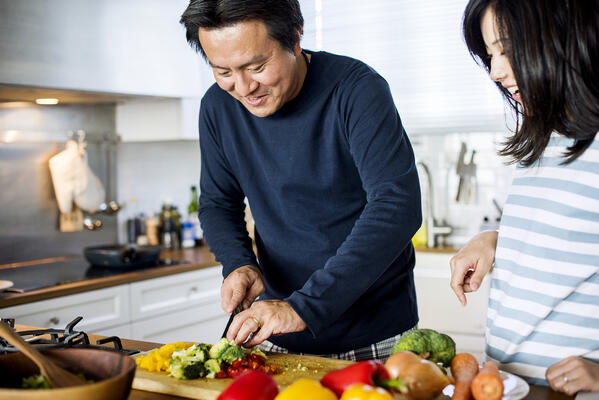 couple cooking healthy dinner together in the kitchen