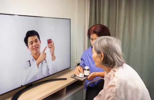 A patient working with a bedside and virtual nurse