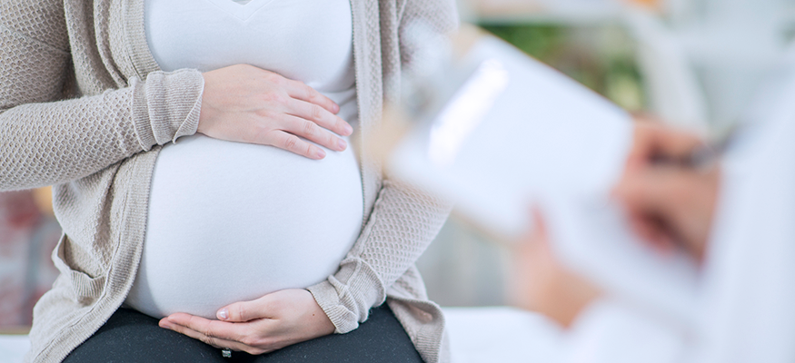 A young mother holding her stomach