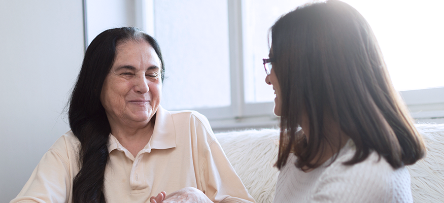 A nursing helping an older woman out