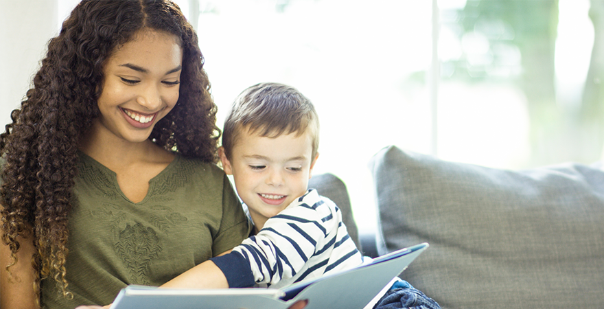 Babysitter reading to boy