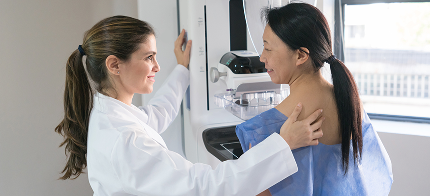 A female provider helping a woman with a mammogram
