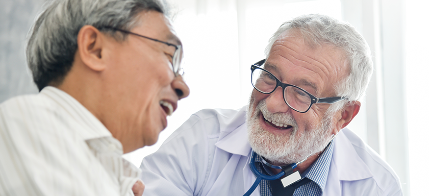 A male doctor and male patient laughing