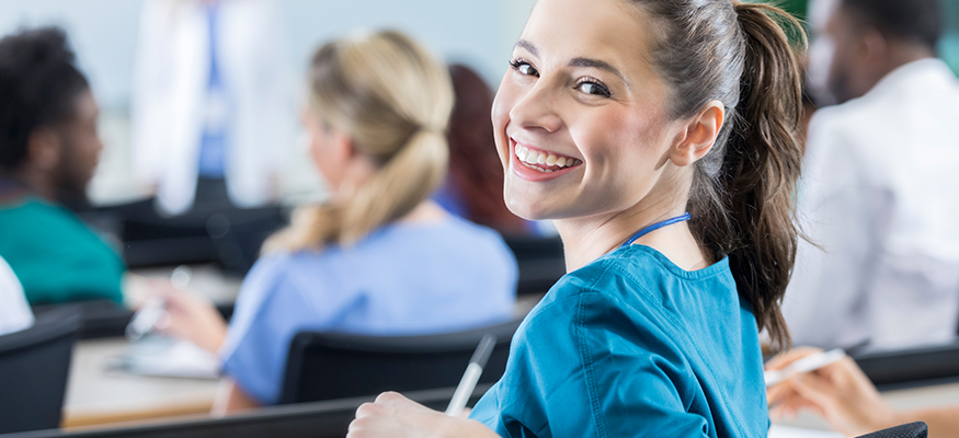 A cheerful nurse student looking at the camera