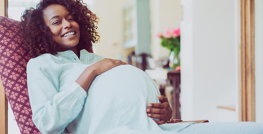 A pregnant woman holding her stomach