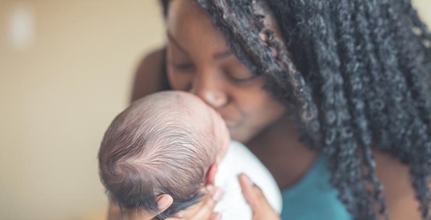 A mother kissing her baby