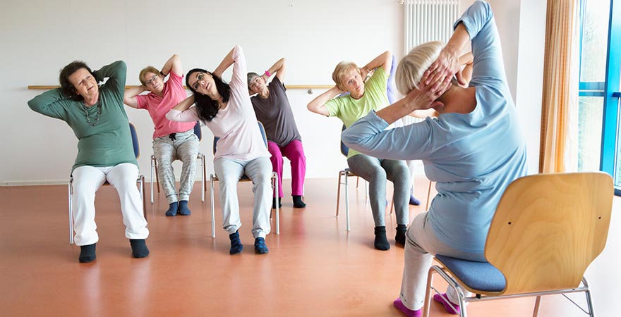 A group of women working out on chairs