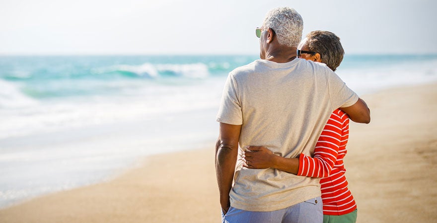 An older couple looking out at the beach