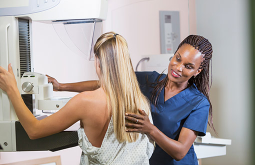 A woman receiving a mammogram