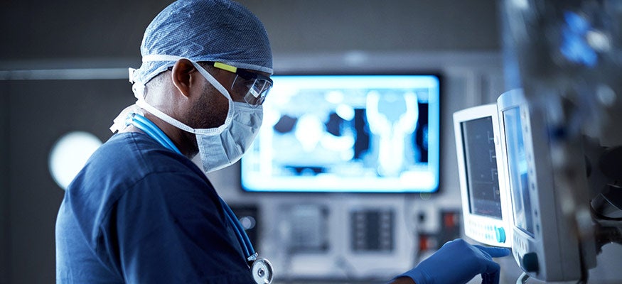 A doctor looking at a radiology screen