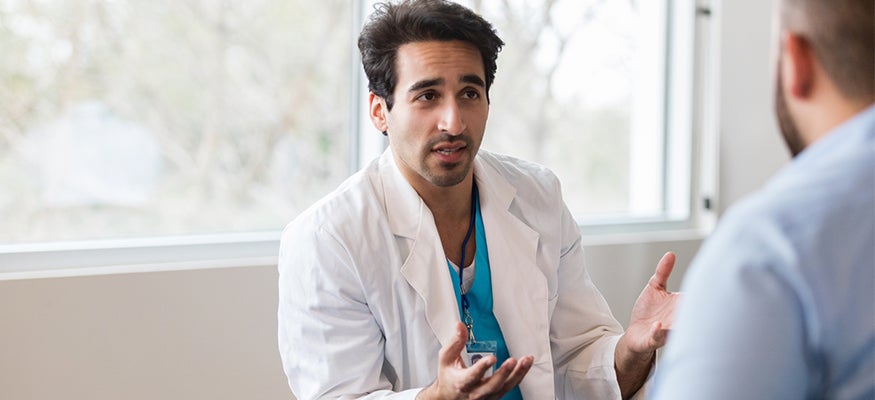 A doctor talking to a patient in their office