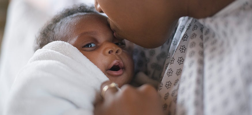 A newborn in her mom's arms