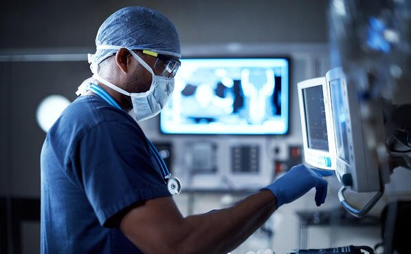 an interventional radiologist checking a machine
