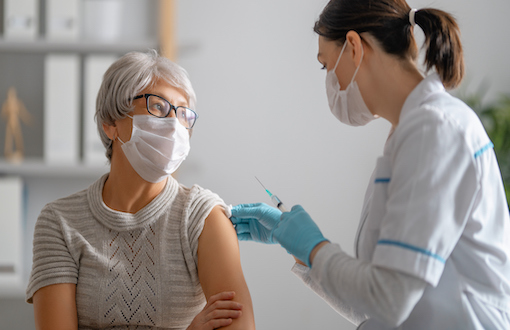 a woman receiving a COVID vaccine