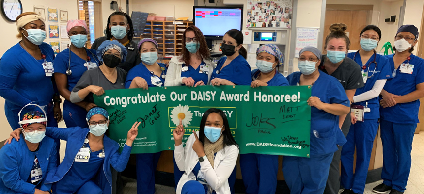 A group of Chesapeake Nurses with the DAISY award banner