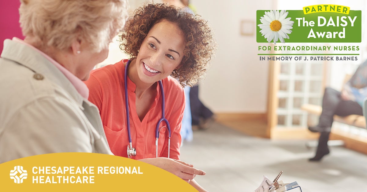  a nurse talking with an elderly patient with the daisy award logo in the top right hand corner