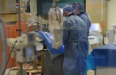 Dr. McKechnie performing first robotic-assisted coronary angioplasty with Corindus