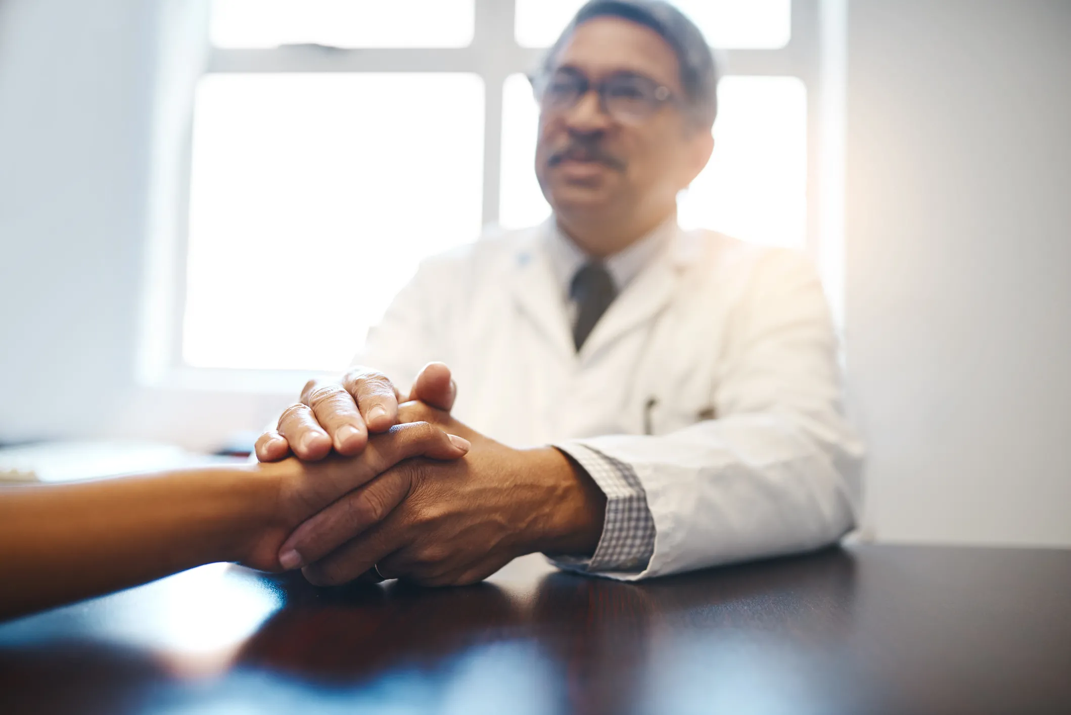 a doctor holding a patient's hand