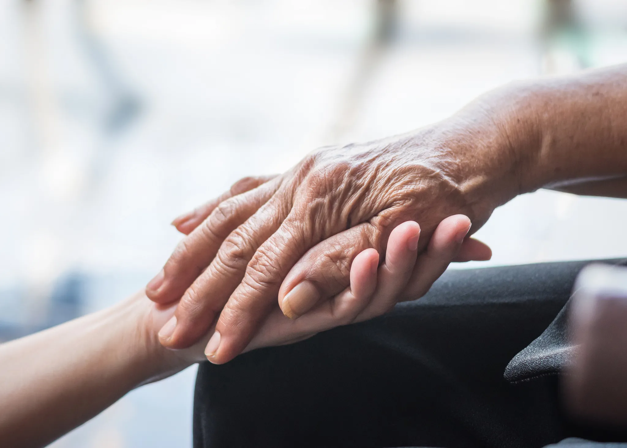 elders hands being held