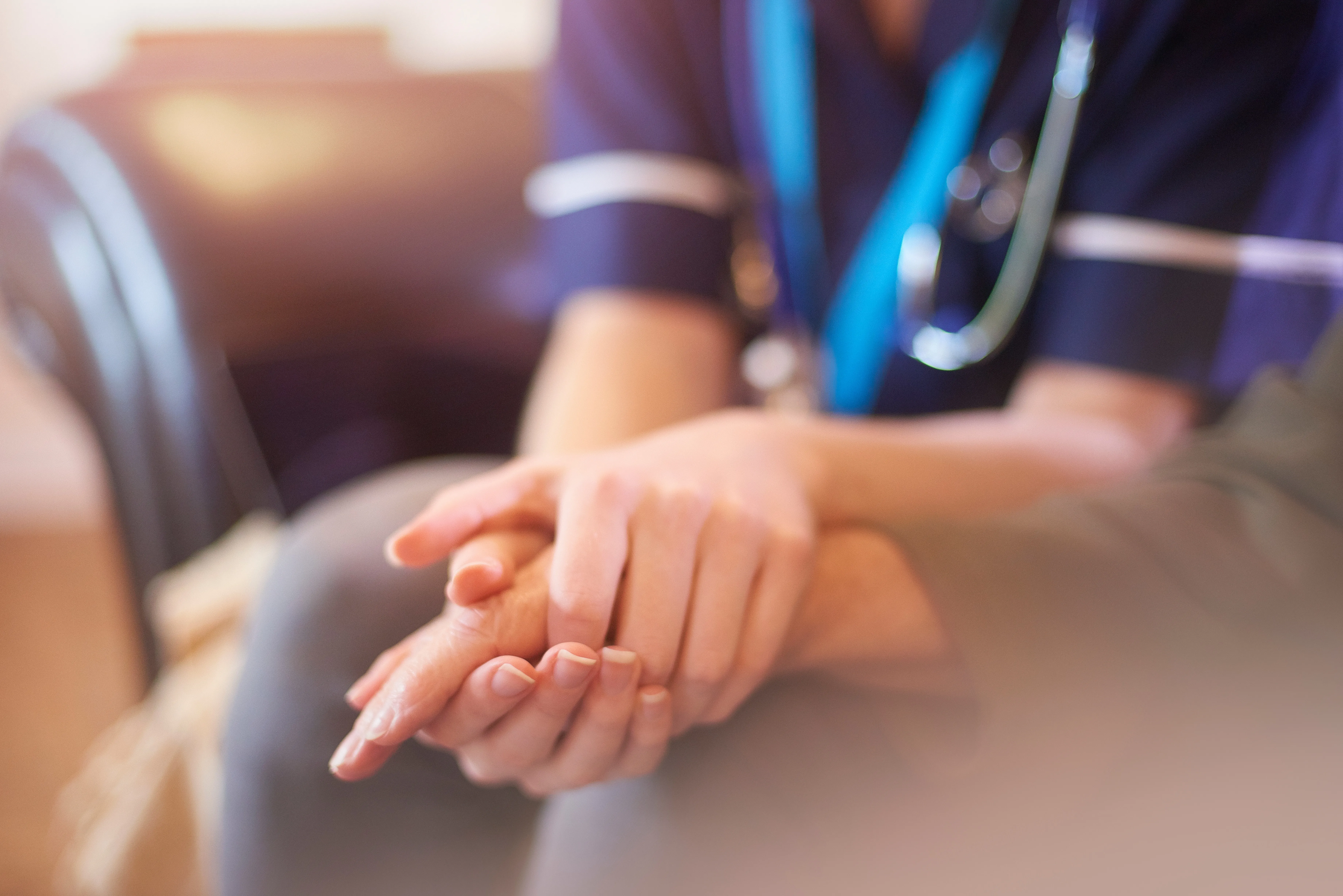 woman holding caregivers hand