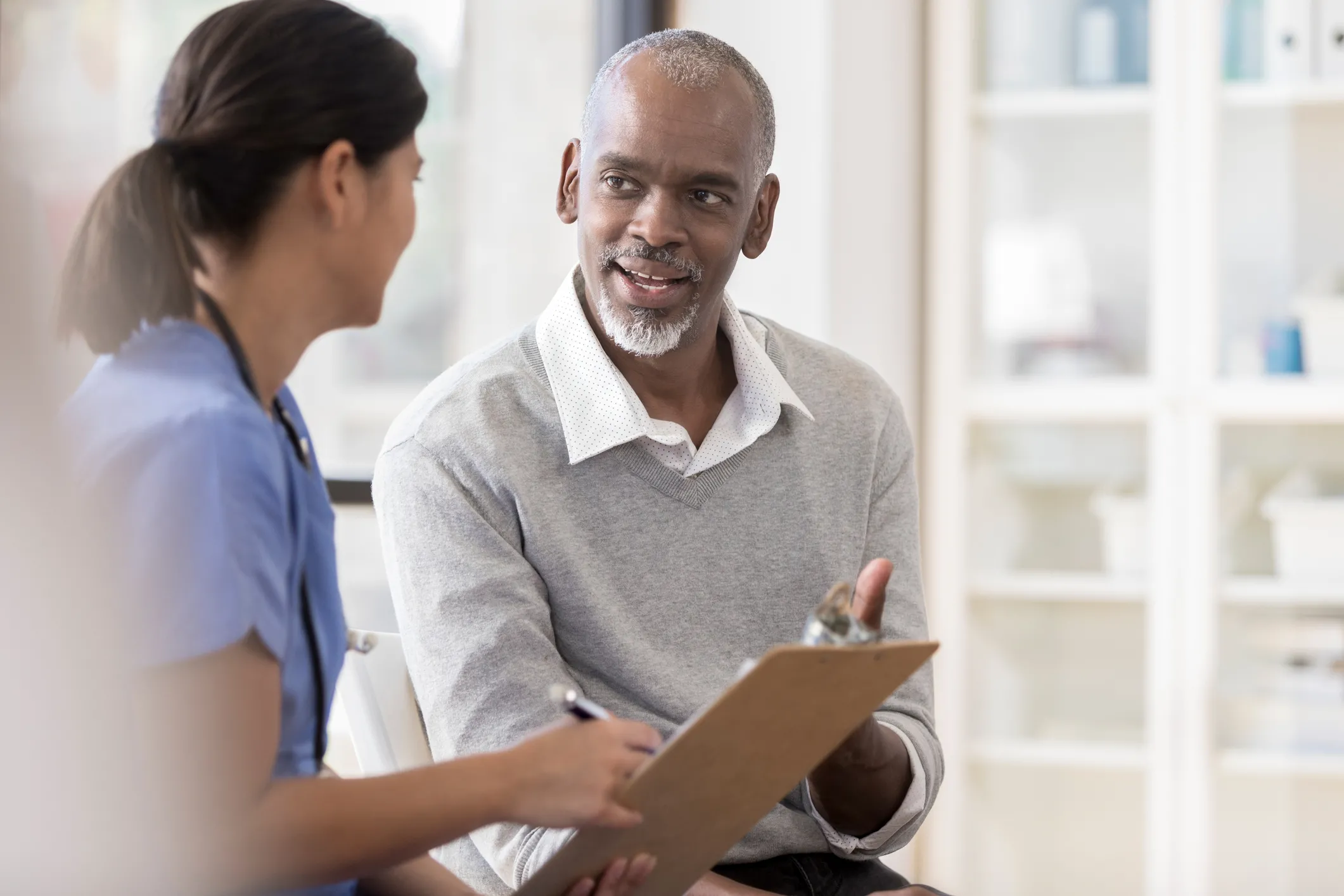 man talking to nurse