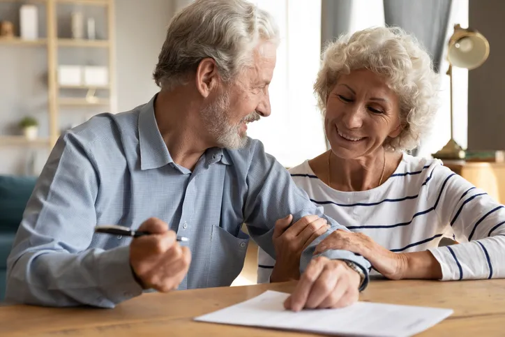 70s couple discuss agreement signing advance directive