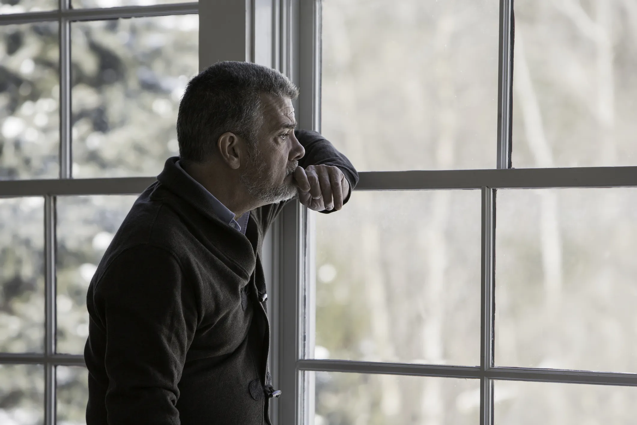 Man looking out window