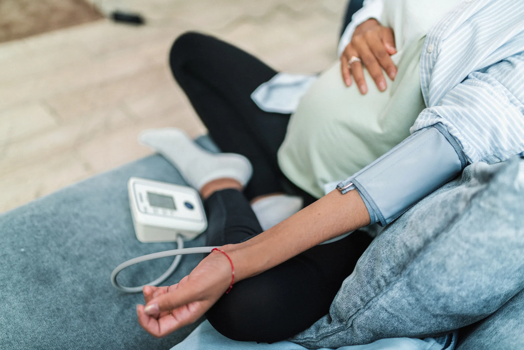 a pregnant woman checking blood pressure