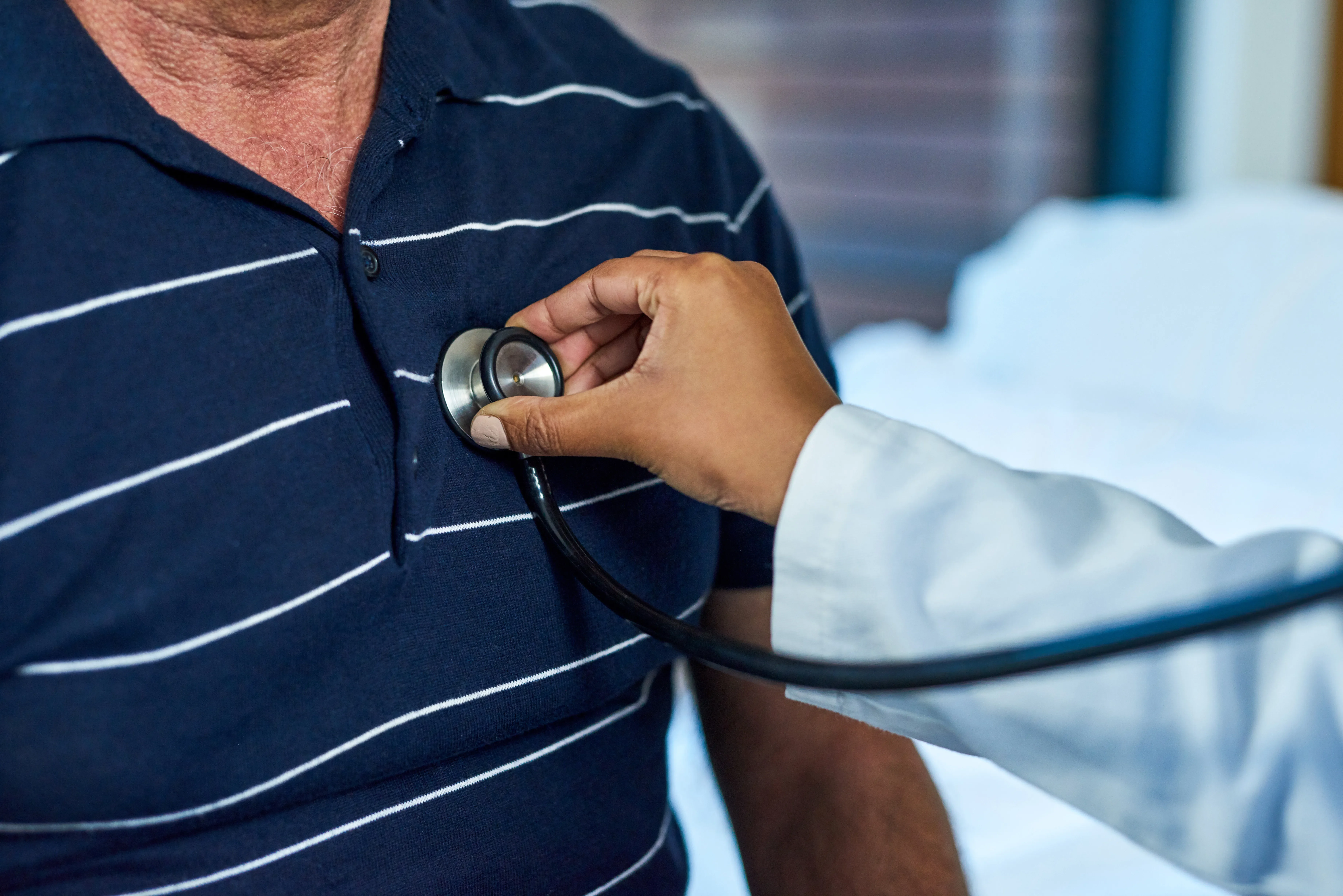 a doctor checking a patient's lungs